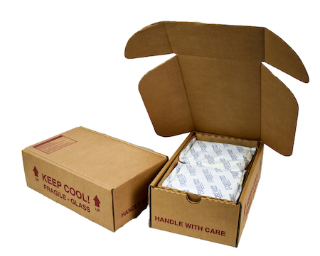 One cold pack shipper box closed next to another one open against a white background